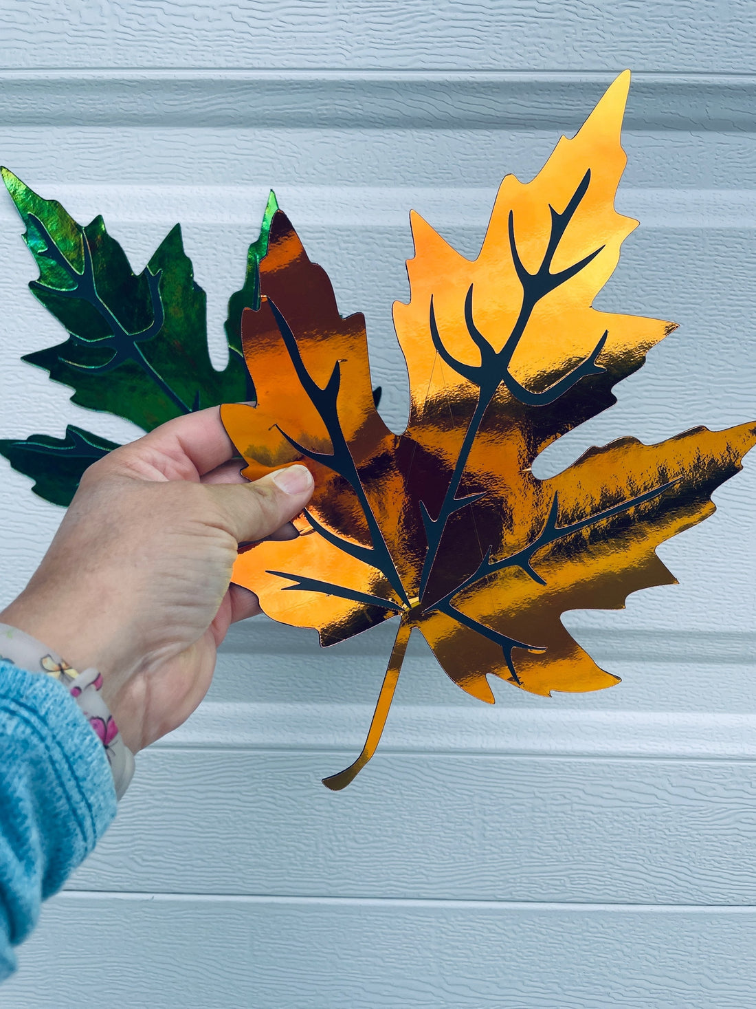 Iridescent fall magnetic leaves on a garage door